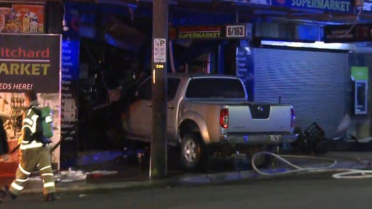 Manhunt after ute rams into shop